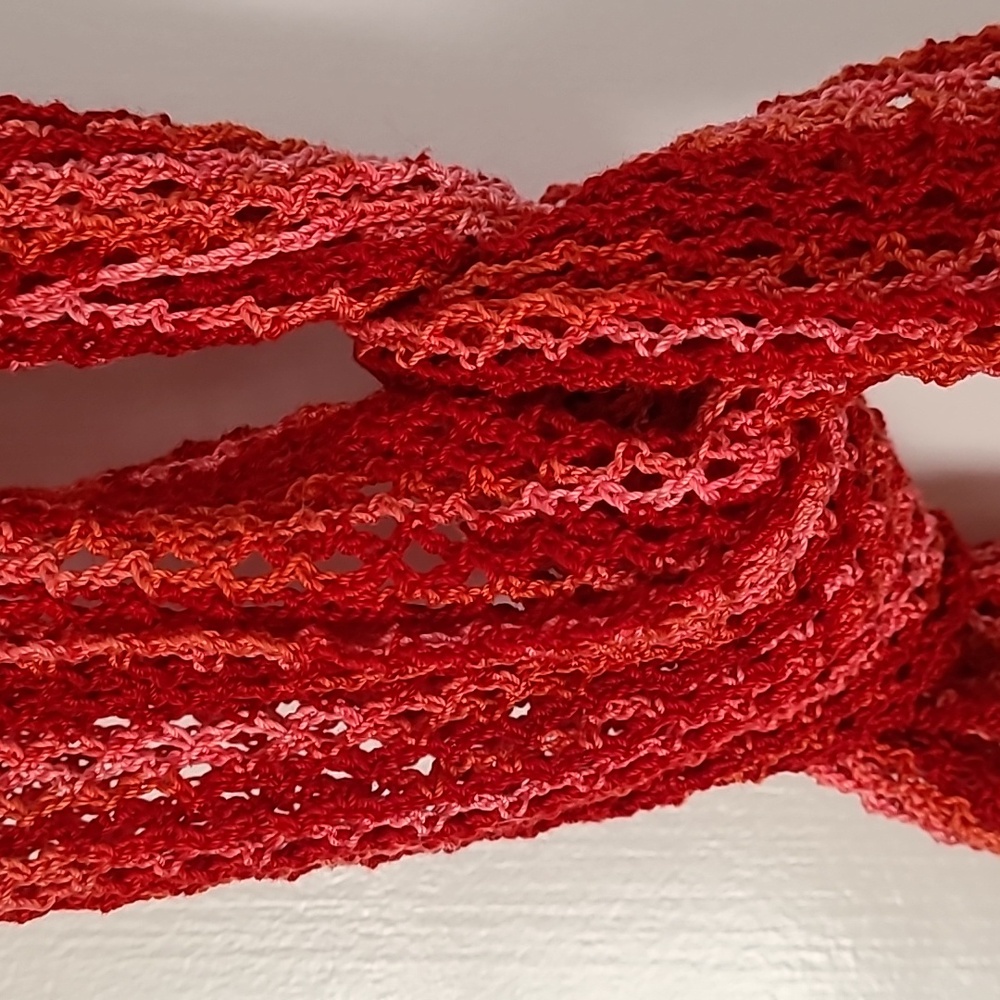 NWOT Handcrafted  crocheted scarf.  Shades of Red and Pink.  Approx. 100…